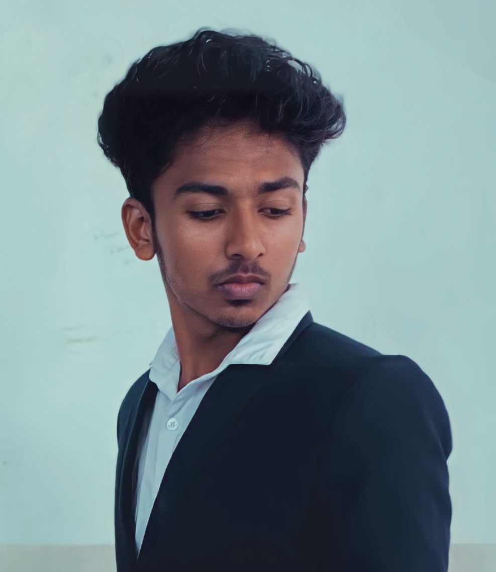 Poovarasan D smiling, wearing formal attire, standing against a neutral background. The emotional tone is confident and approachable.